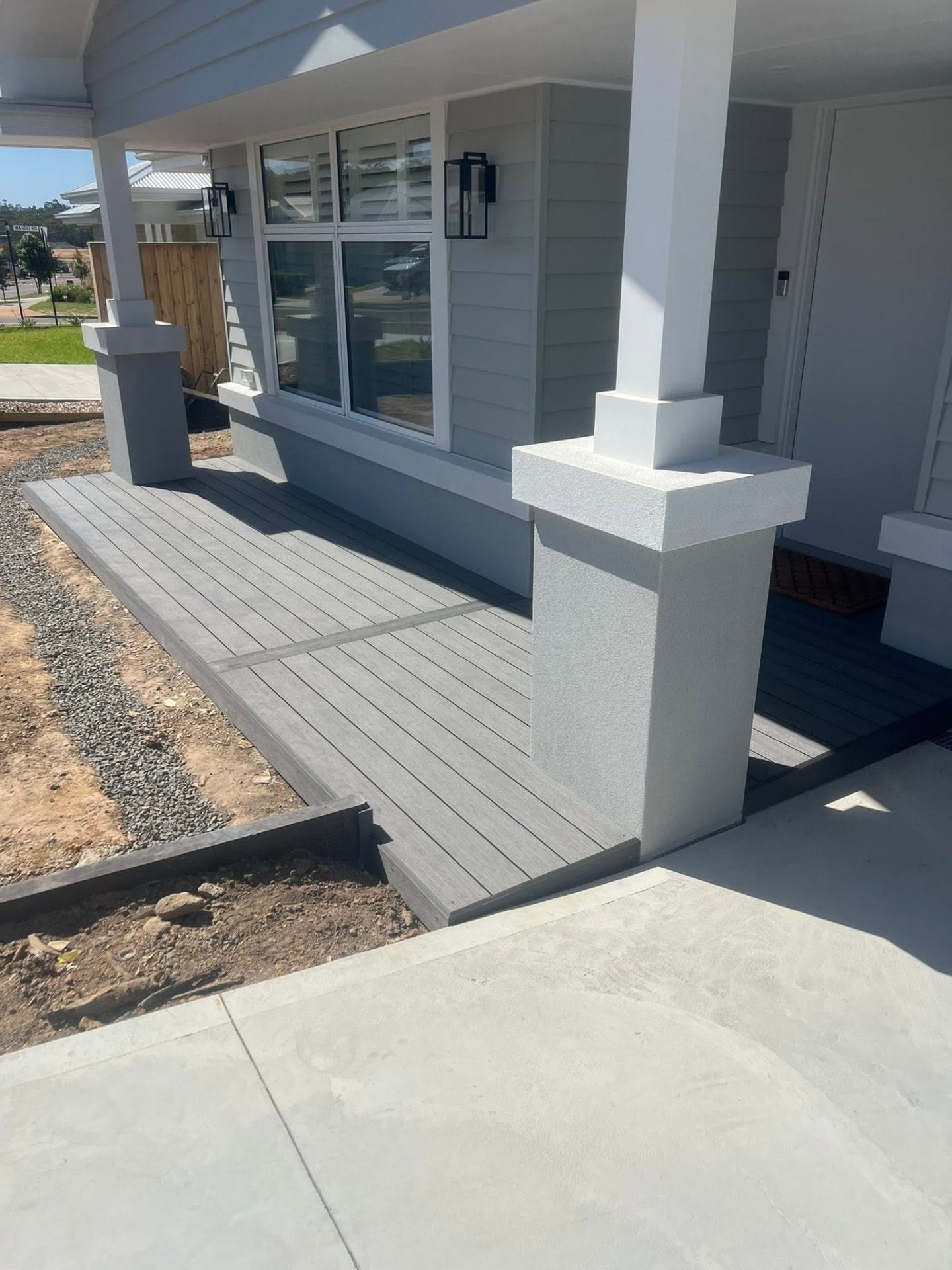 Grey composite decking laid on a front verandah