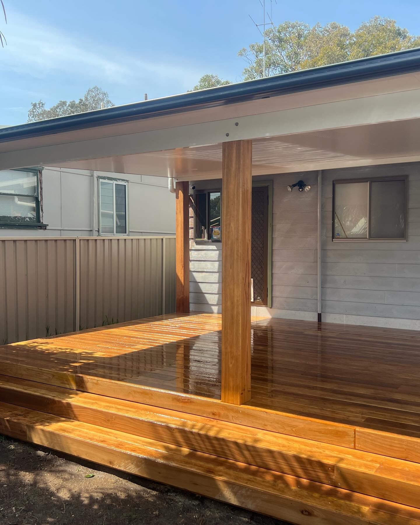Freshly oiled hardwood deck and steps under a new awning